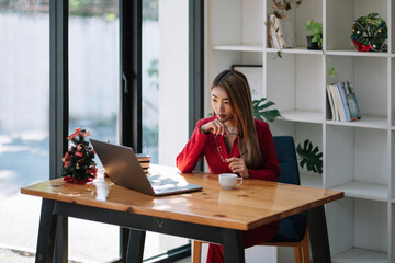 Portrait of attractive asian businesswoman working with laptop at her office