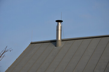 right dark roof in the mountains. the snow is restrained by hooks, which do not allow to let an...
