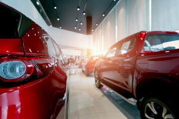 Rear view of red car parked in luxury showroom. Car dealership office. New car parked in modern...