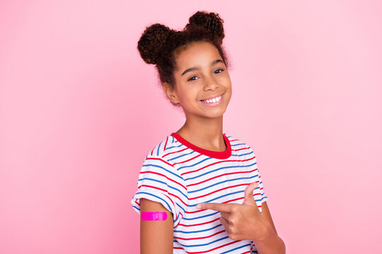 Photo of african american brunette small childhood stylish girl wear t-shirt model point vaccine isolated on pink color background