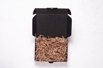 Black cardboard box on wooden office desk