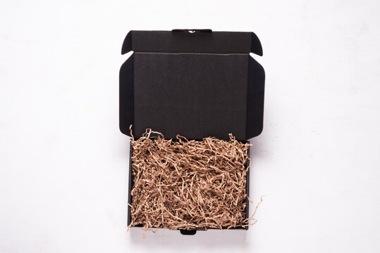 Black cardboard box on wooden office desk
