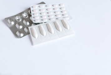 Drugs for treatment: medical pills in a blister pack and medical candles on a white background with copy space