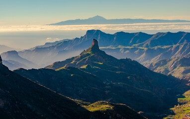 High summit landscapes of the Canary Islands with green vegetation after the rains with afternoon light, beautiful colors with the Roque Nublo, the Bentayga and the Teide in the beautiful background