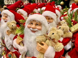 Bright, soft, New Year's toys of Santa Claus. Holiday gifts on a store shelf on Christmas Eve. Preparing for the new year, selling in a toy store.