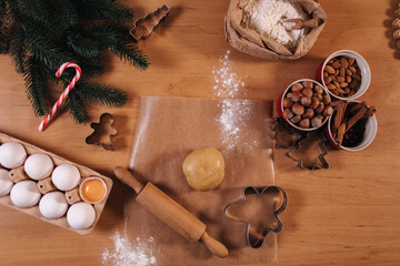 Home made sweets concept. Christmas bakery of gingerbread. Cinnamon and nuts in red dishes. Top view