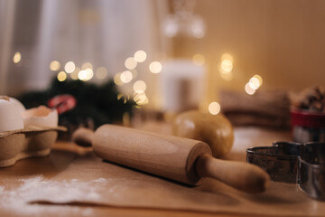 Polling pin for making gingerbread. Close-up of rolling raw dough for gingerbread. Christmas mood. Preparing for hollidays