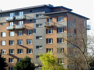 Fototapeta premium Block of flats, urban building, real estate concept. Council tower block. Expensive prices for flats and apartments in the city.