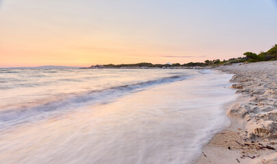 Fototapeta na wymiar Karydi beach, Sithonia peninsula, Chalkidiki, Greece; scenic sunrise over sandy beach early in the morning with Mt. Athos in the background; long exposure shot of beautiful and peaceful beach at dawn