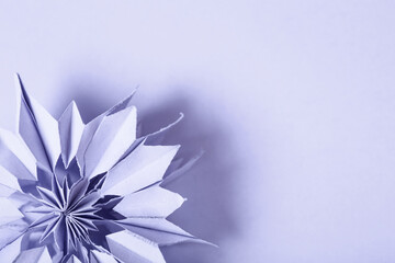 color of year 2022 - Very Peri. minimal lilac background with paper shape. purple flower star with...
