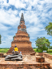 Fototapeta na wymiar Old brick pagoda in ancient temple in Ayutthaya, old capital city of Thailand, UNESCO World heritage place, under cloudy blue sky in summer