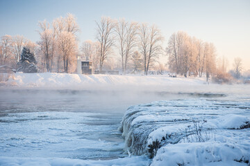 Frosty Venta river waterfall, the widest waterfall in Europe, in sunny, foggy winter morning,...