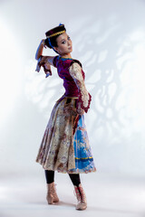 Confident Asian Japanese Female Ballet Dancer In Stage Outfit Costume Posing in Dance Pose With Lifted Hand and Patterns Over White Background.