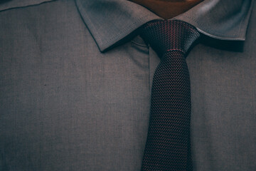 Closeup of a tie on the man's neck.