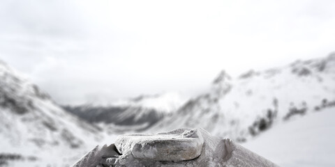 Stone background cover of snow and winter landscape of mountains. 