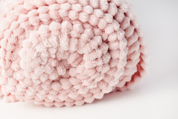 Roll up soft pastel pink fleece throw fabric with lines. White background, copy space