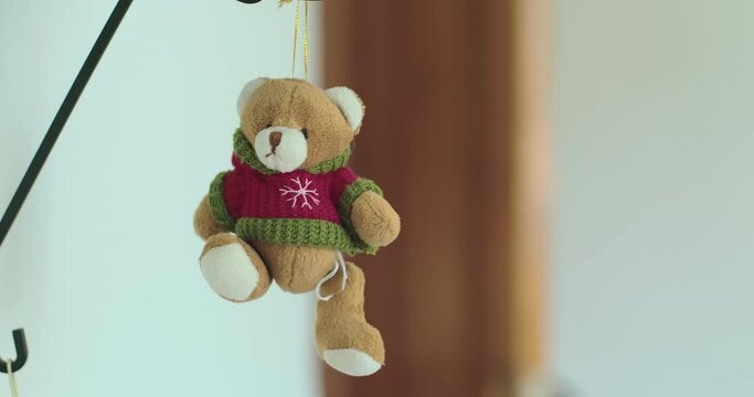 Soft toy. A cute bear toy hangs over the shelves.
