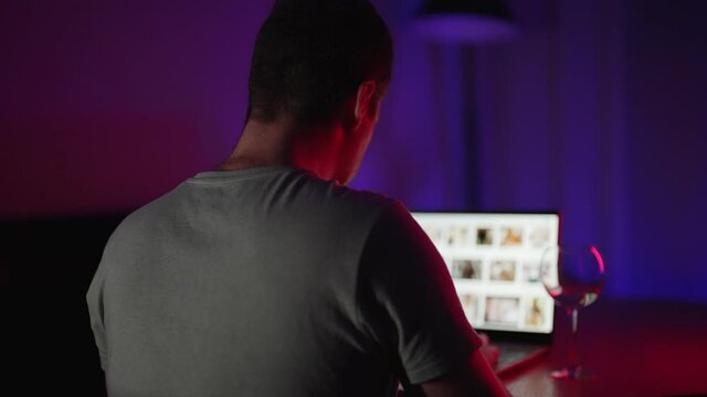 Man secretly watching porn sites at night.