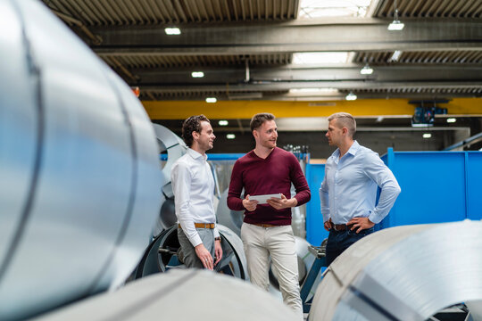 Male professionals having discussion in factory