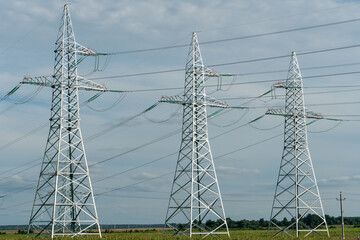 Metal supports of power lines. Poles for holding wires transmitting electricity from the generator...