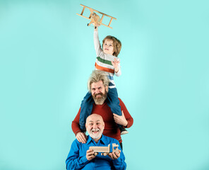 Grandfather father and son playing with toy plane. Happy man family. Three men generation. Happy...