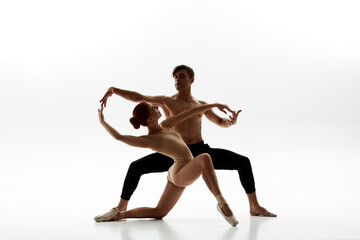 Elegant couple dancing ballet on white background