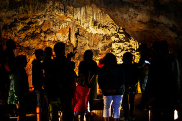 excursion with tourists to the Sfendoni cave with stalactites, stalagmites and stalagnates underground,