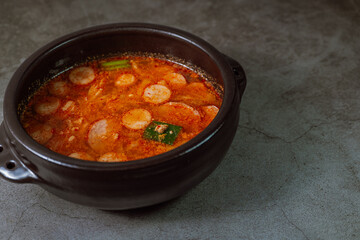 Buddaejjigae, Korean style spicy stew of wieners, luncheon meat, macaroni and vegetables.