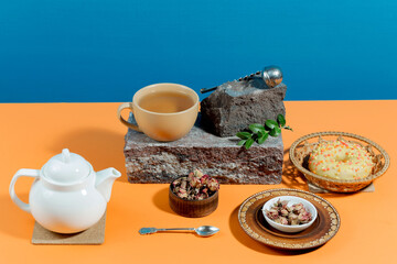 Tea with dessert on a bright colored background 