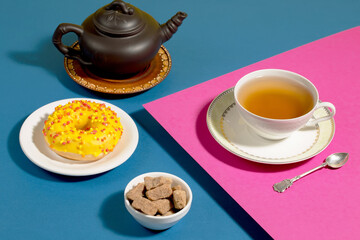 Tea with dessert on a bright colored background 
