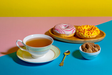 Tea with dessert on a bright colored background 