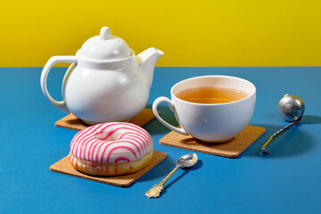 Tea with dessert on a bright colored background 