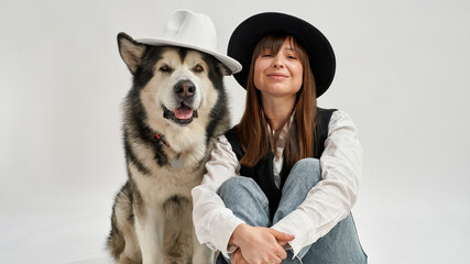 Girl and Siberian Husky dog looking at camera