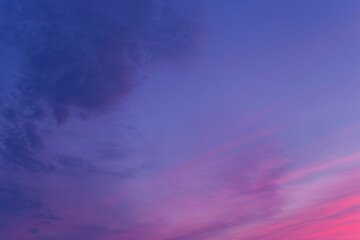 Beautiful sky horizontal background at sunset in purple pink blue color palette - trendy very peri color shade