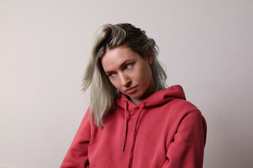 Obraz premium Portrait of sad and worried woman with colourful hair posing in the studio.