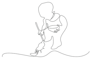 A child lovingly feeds a bird.