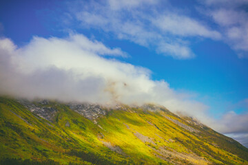 Beautiful mountain peak in the clouds. Nature of Norway. Senja Island