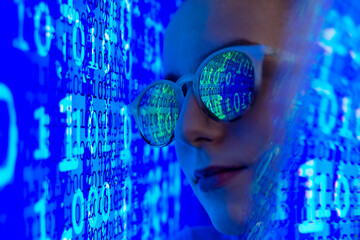 Female computer criminal checking binary code on computer device