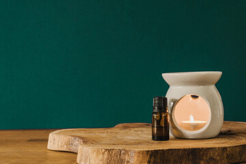 Ceramic oil burner on the green background copy space