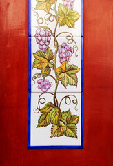 Vertical tile with grape leaves and bunches of grapes on a blood red background. Decorative illustration for wine and oenology 