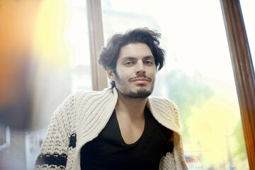 Portrait of young handsome man wearing cardigan