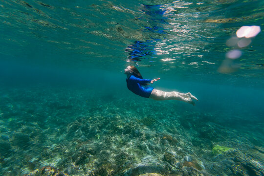 Indonesia, Bali, Young woman snorkeling in Nusa Penida island