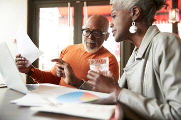 Male and female colleagues discussing at restaurant