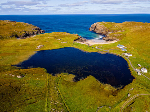 UK, Scotland, Aerial view of Lake Dhailbeag in summer with clear line of horizon ove sea in background