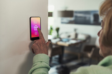 Woman touching wifi icon on home automation device