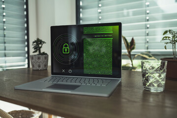 Laptop with padlock icon on table at home