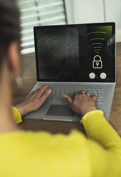 Woman accessing data on laptop at home