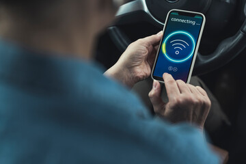 Woman connecting smart phone with wifi in car