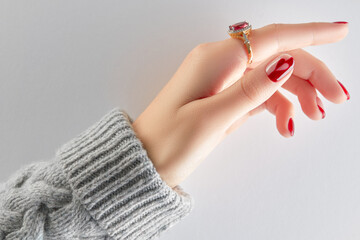 Manicured womans hand in sweater. Manicure, pedicure design trends