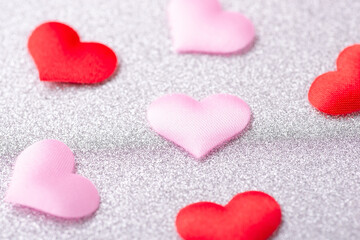 Colorful red and pink hearts on silver background. Love concept